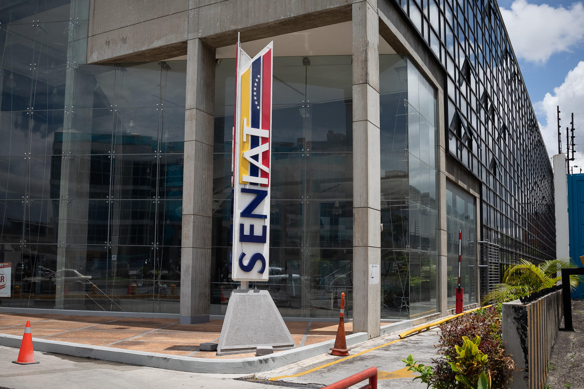 Exterior del edificio del SENIAT con letrero y fachada moderna