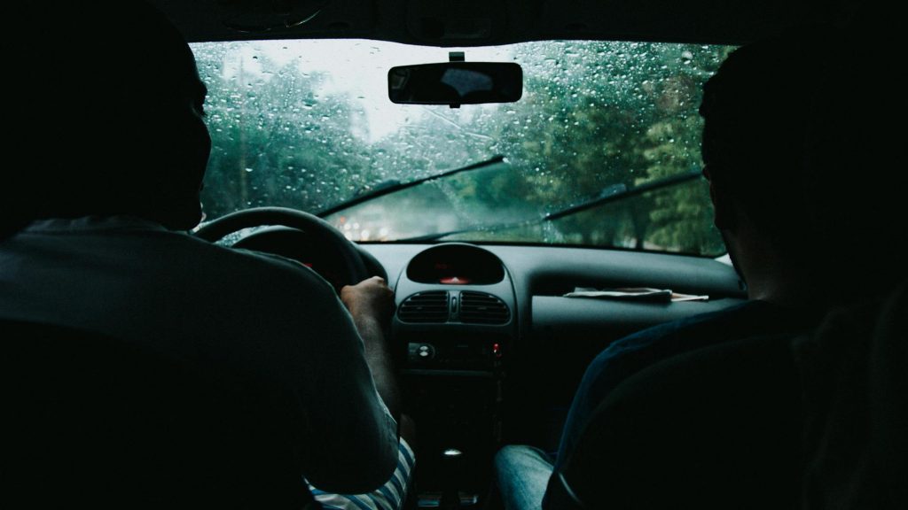 two men inside moving vehicle