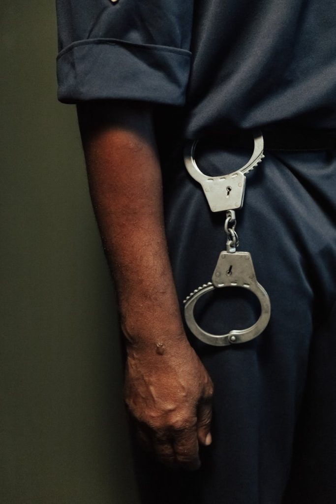 close up of handcuffs hanging by policeman belt